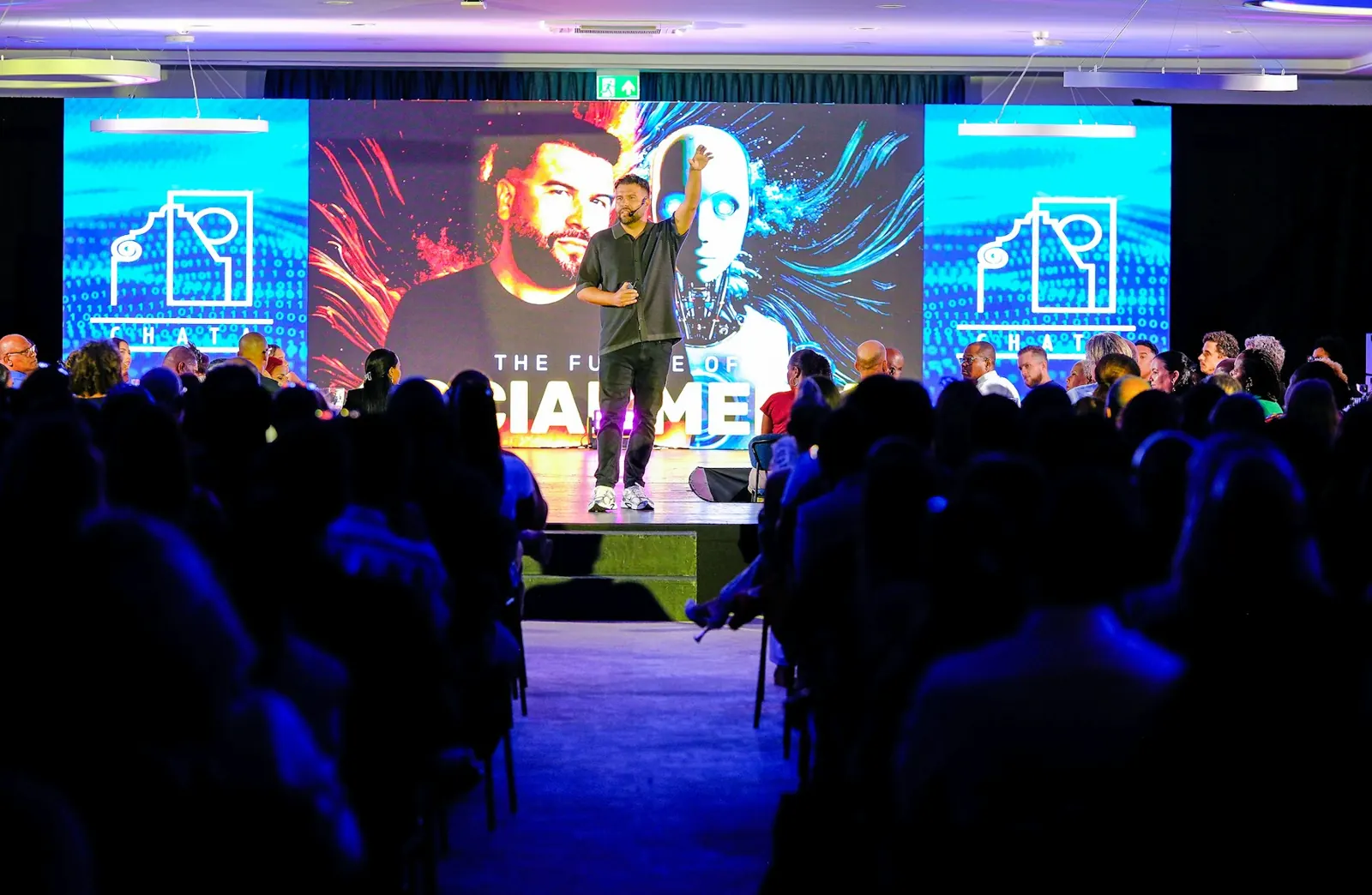 Speaker on stage at a corporate summit with LED backdrop