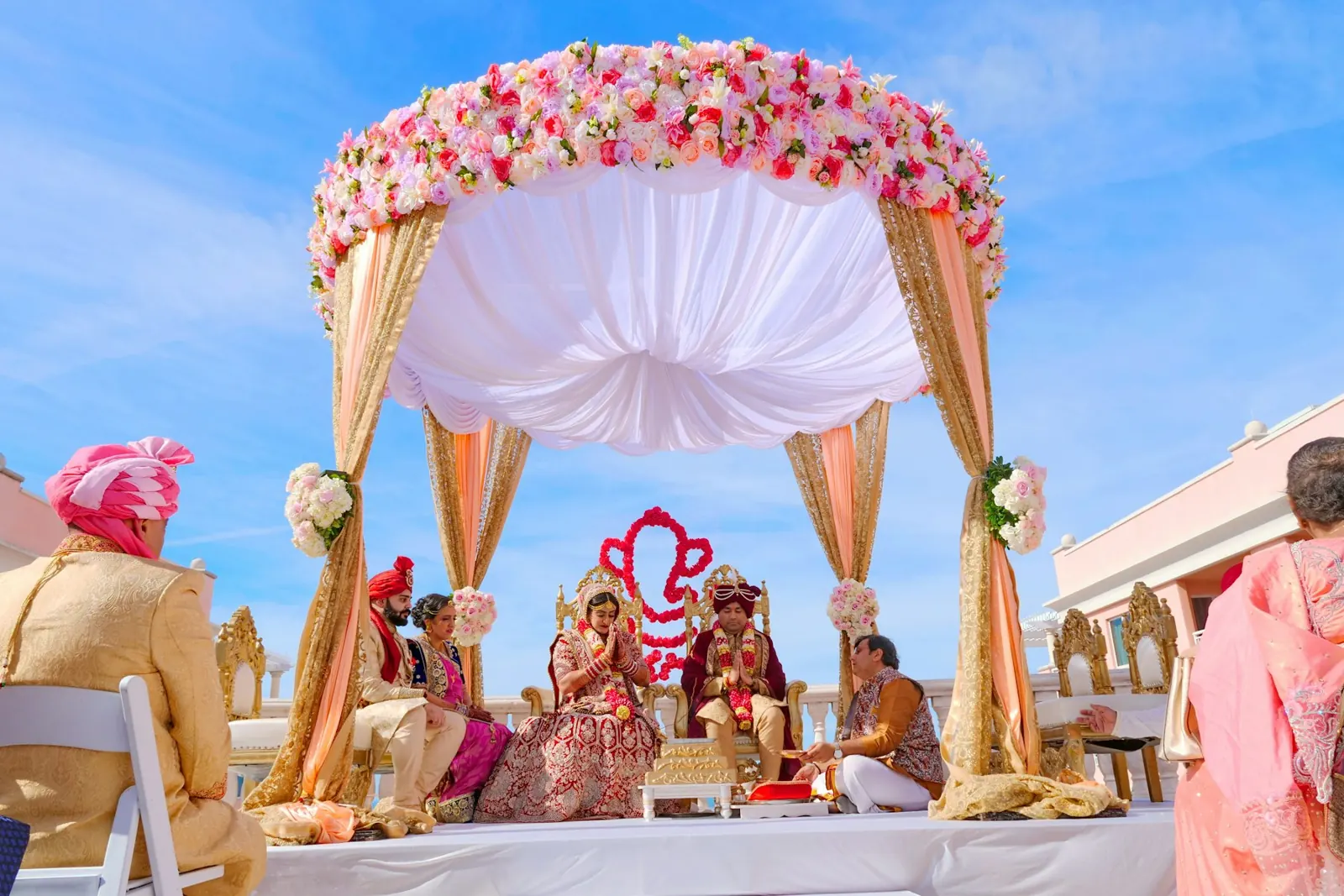 Indian wedding ceremony under a floral mandap